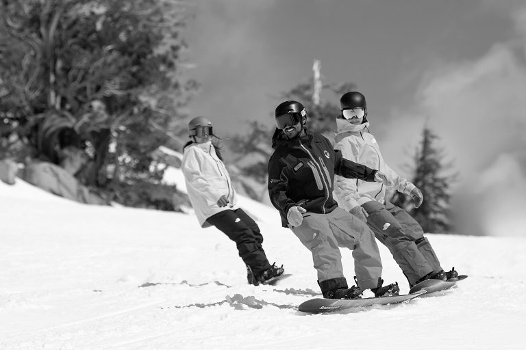 Snowboarders participating in a group lesson